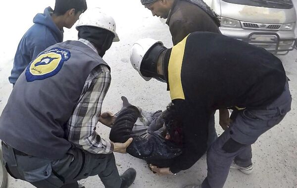 This photo provided by the Syrian Civil Defense White Helmets, which has been authenticated based on its contents and other AP reporting, shows members of the Syrian Civil Defense group helping a wounded man after airstrikes hit Ghouta, a suburb of Damascus, Syria, Thursday, March. 1, 2018 This photo provided by the Syrian Civil Defense White Helmets, which has been authenticated based on its contents and other AP reporting, shows members of the Syrian Civil Defense group helping a wounded man after airstrikes hit Ghouta, a suburb of Damascus, Syria, Thursday, March. 1, 2018 - Sputnik International