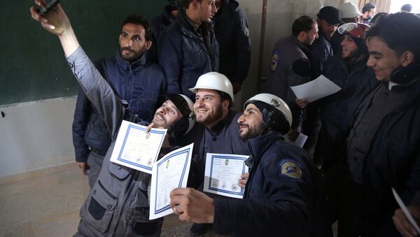Members of the Syrian Civil Defence, known as the White Helmets, take a selfie with their certificates after taking part in a training session in the rebel-held eastern Ghouta area, east of the capital Damascus, on November 22, 2016 - Sputnik International