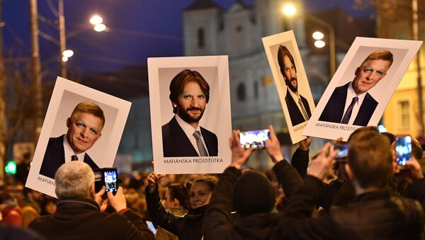 Protesters holds placards bearing faceted portraits of Slovakia's Prime Minister Robert Foco and Foreign Minister Robert Kalinak during a rally under the slogan For a Decent Slovakia, against corruption and to pay tribute to murdered Slovak journalist Jan Kuciak and his fiancee Martina Kusnirova on March 9, 2018 at the Slovak National Uprising (SNP) square in Bratislava, Slovakia - Sputnik International