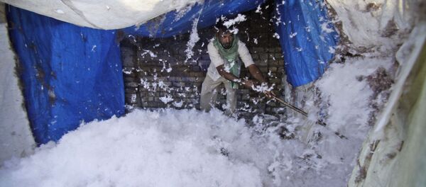 In this Feb. 18, 2014 file photo, an Indian worker processes cotton for quilts at a factory on the outskirts of Jammu, India In this Feb. 18, 2014 file photo, an Indian worker processes cotton for quilts at a factory on the outskirts of Jammu, India - Sputnik International