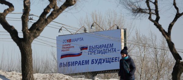 A woman walks past a billboard advertising the upcoming presidential election, in Krasnoyarsk, Russia March 11, 2018 A woman walks past a billboard advertising the upcoming presidential election, in Krasnoyarsk, Russia March 11, 2018 - Sputnik International