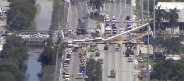 In this frame from video, emergency personnel work at the scene of a collapsed bridge in the Miami area, Thursday, March 15, 2018. In this frame from video, emergency personnel work at the scene of a collapsed bridge in the Miami area, Thursday, March 15, 2018. - Sputnik International