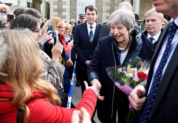 Britain's Prime Minister Theresa May greets people after visiting the scene where former Russian intelligence officer Sergei Skripal and his daughter Yulia were found after they were poisoned with a nerve agent, in Salisbury, Britain March 15, 2018 Britain's Prime Minister Theresa May greets people after visiting the scene where former Russian intelligence officer Sergei Skripal and his daughter Yulia were found after they were poisoned with a nerve agent, in Salisbury, Britain March 15, 2018 - Sputnik International
