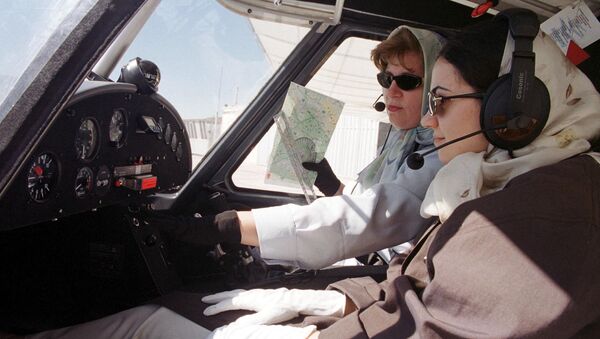Iranian co-pilot and instructor Nahid Qafarian carries out a pre-flight test 01 June 2001 in the cabin of a German-made Ikarus C-42 light plane, together with her student Maryam Azaran (R), who is one of only three women taking flying lessons at a private flying club outside the Iranian city of Qazvin, some 100 kms west of Tehran - Sputnik International