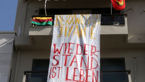 A banner reading Resistance is life, solidarity to Afrin hangs at the German Consulate in Heraklion, Crete Island on March 16, 2018, after a group of demonstrators occupied the building - Sputnik International