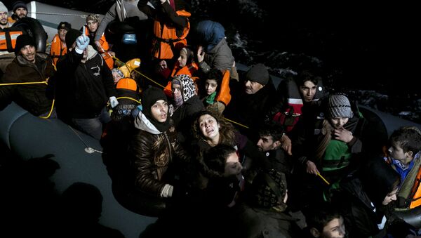 (File) Refugees and migrants aboard an inflatable dinghy are about to be rescued by MOAS (Migrant Offshore Aid Station) while attempting to reach the Greek island of Agathonisi, Dodecanese, southeastern Agean Sea, overnight on January 16, 2016 - Sputnik International