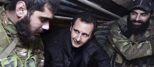 (File) This Wednesday, Dec. 31, 2014, file photo released by the Syrian official news agency SANA, Syrian President Bashar Assad, center, speaks with Syrian troops during his visit to the front line in the eastern Damascus district of Jobar, Syria (File) This Wednesday, Dec. 31, 2014, file photo released by the Syrian official news agency SANA, Syrian President Bashar Assad, center, speaks with Syrian troops during his visit to the front line in the eastern Damascus district of Jobar, Syria - Sputnik International
