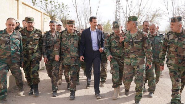 Syrian President Bashar al-Assad walks with Syrian army soldiers in eastern Ghouta, Syria, March 18, 2018 - Sputnik International