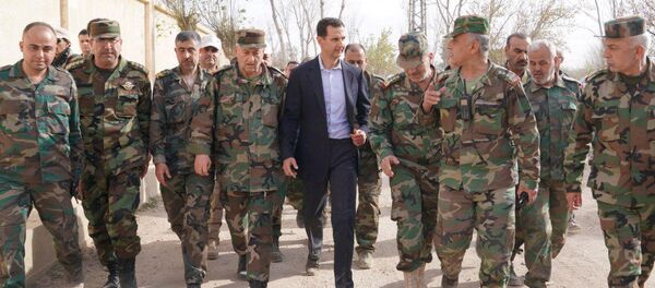 Syrian President Bashar al-Assad walks with Syrian army soldiers in eastern Ghouta, Syria, March 18, 2018 Syrian President Bashar al-Assad walks with Syrian army soldiers in eastern Ghouta, Syria, March 18, 2018 - Sputnik International