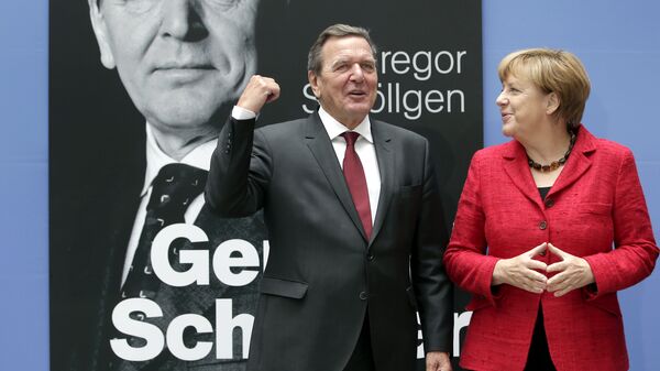 German Chancellor Angela Merkel, right, and former German Chancellor Gerhard Schroeder, left, pose during a photo call prior to the book presentation of Schroeder's biography in Berlin, Germany, Tuesday, Sept. 22, 2015 - Sputnik International