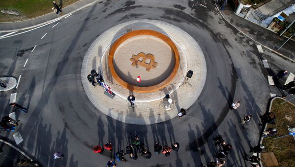 People attend the opening ceremony of world's first public Bitcoin monument, placed at a roundabout connecting two roads at the city centre in Kranj, Slovenia, March 13, 2018 - Sputnik International