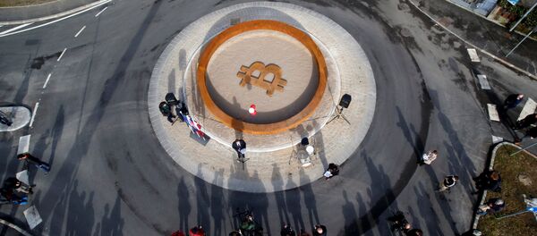 People attend the opening ceremony of world's first public Bitcoin monument, placed at a roundabout connecting two roads at the city centre in Kranj, Slovenia, March 13, 2018 People attend the opening ceremony of world's first public Bitcoin monument, placed at a roundabout connecting two roads at the city centre in Kranj, Slovenia, March 13, 2018 - Sputnik International