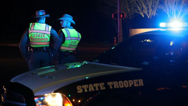 Texas state troopers keep watch at a checkpoint as nearby law enforcement personnel investigate an incident that they said involved an incendiary device in the 9800 block of Brodie Lane in Austin, Texas, U.S - Sputnik International
