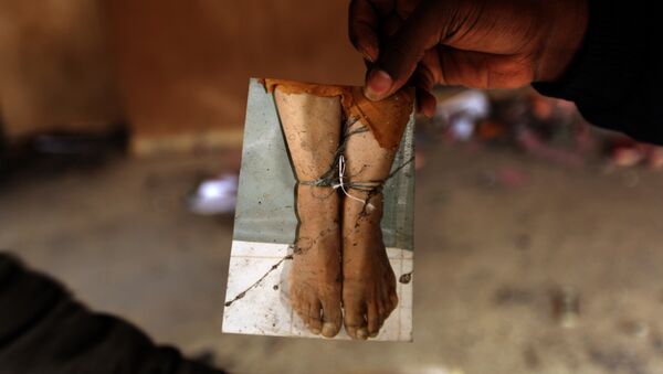 A Libyan protester shows a picture found in the ransacked headquarters of the judiciary police in Benghazi. (File) - Sputnik International