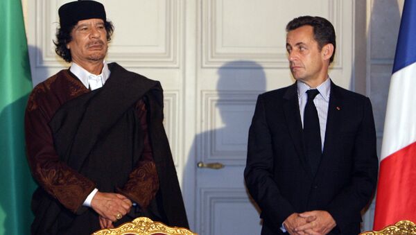 Libyan leader Col. Moammar Gadhafi, left, and French President Nicolas Sarkozy, pose during a signing ceremony at the Elysee Palace, Paris. (File) - Sputnik International