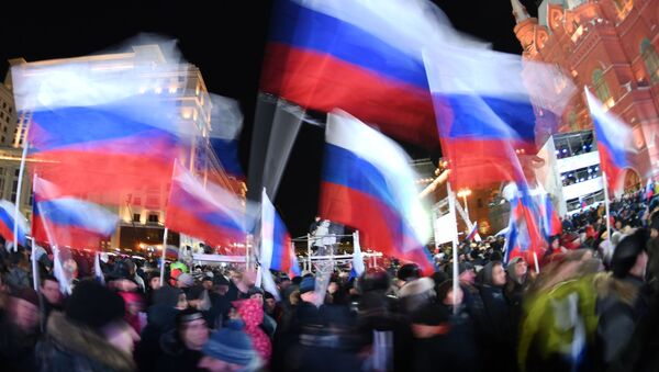 Participants before the meeting and concert at Moscow's Manezhnaya Square staged to mark the 4th anniversary of Crimea's reunification with Russia - Sputnik International