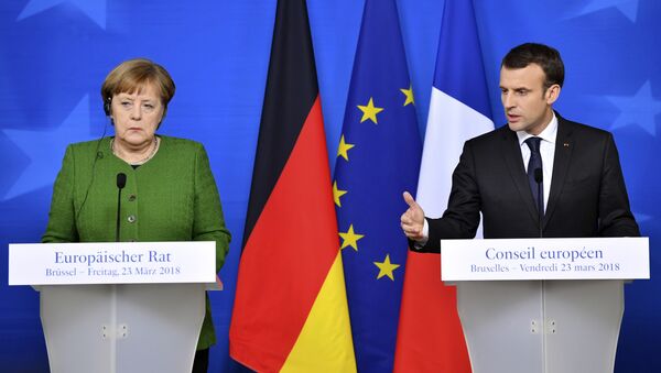 French President Emmanuel Macron, right, and German Chancellor Angela Merkel participate in a media conference at the conclusion of an EU summit in Brussels - Sputnik International