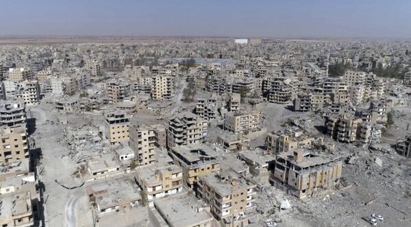 (File) This Thursday, Oct. 19, 2017 frame grab made from drone video shows damaged buildings in Raqqa, Syria (File) This Thursday, Oct. 19, 2017 frame grab made from drone video shows damaged buildings in Raqqa, Syria - Sputnik International