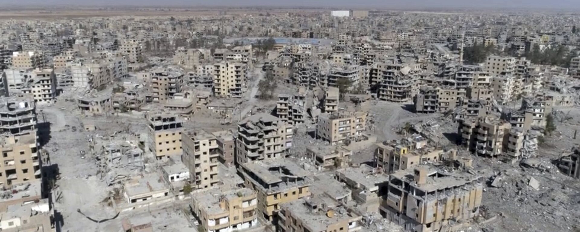 (File) This Thursday, Oct. 19, 2017 frame grab made from drone video shows damaged buildings in Raqqa, Syria - Sputnik International, 1920, 18.04.2022