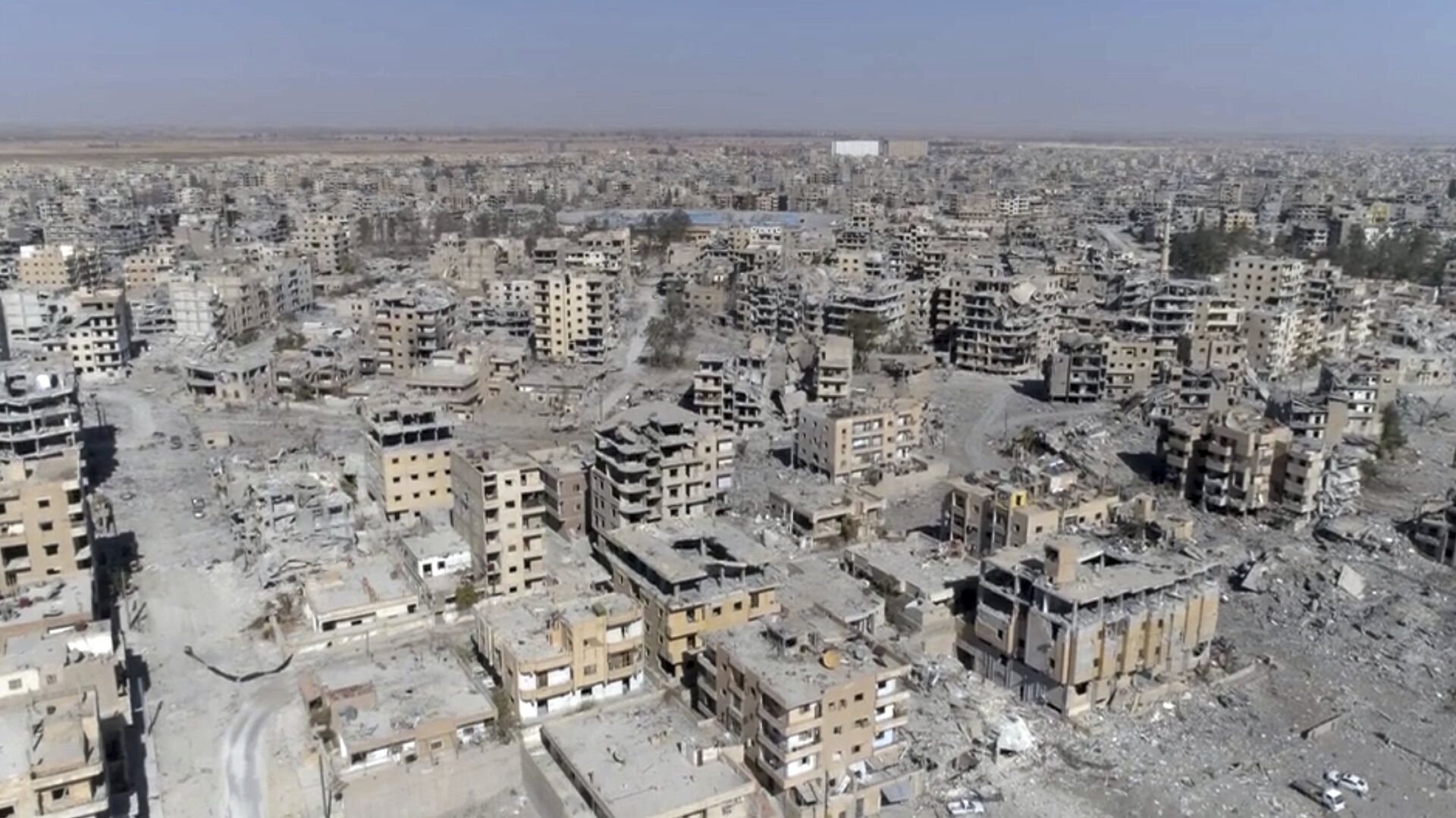 (File) This Thursday, Oct. 19, 2017 frame grab made from drone video shows damaged buildings in Raqqa, Syria - Sputnik International, 1920, 25.03.2022
