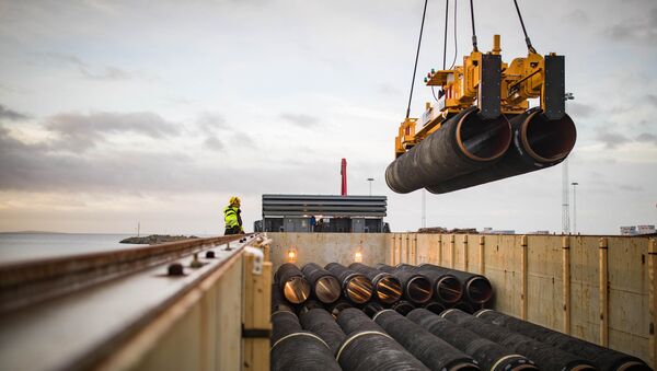 Pipes are loaded onto a vessel in the northern German port of Mukran for transshipment to a storage yard - Sputnik International