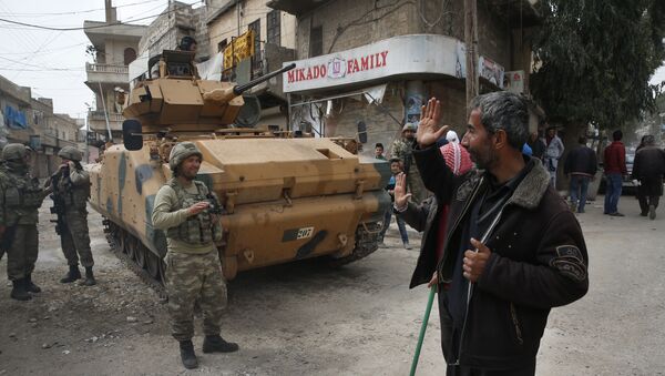 A Syrian man waves to Turkish soldiers securing the streets of the northwestern city of Afrin, Syria, during a Turkish government-organised media tour into northern Syria, Saturday, March 24, 2018 - Sputnik International