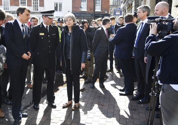 Britain's Prime Minister Theresa May, centre, is briefed by members of the police as she views the area where former Russian double agent Sergei Skripal and his daughter were found critically ill, in Salisbury, England, Thursday, March 15, 2018 Britain's Prime Minister Theresa May, centre, is briefed by members of the police as she views the area where former Russian double agent Sergei Skripal and his daughter were found critically ill, in Salisbury, England, Thursday, March 15, 2018 - Sputnik International