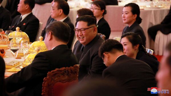 North Korean leader Kim Jong Un smiles during a banquet, as he paid an unofficial visit to Beijing, China, in this undated photo released by North Korea's Korean Central News Agency (KCNA) in Pyongyang March 28, 2018. - Sputnik International