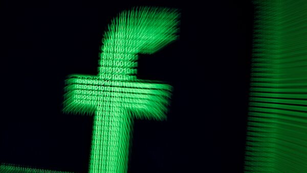 A 3D-printed Facebook logo are seen in front of displayed binary digits in this illustration taken, March 18, 2018 - Sputnik International