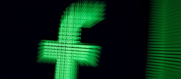 A 3D-printed Facebook logo are seen in front of displayed binary digits in this illustration taken, March 18, 2018 - Sputnik International