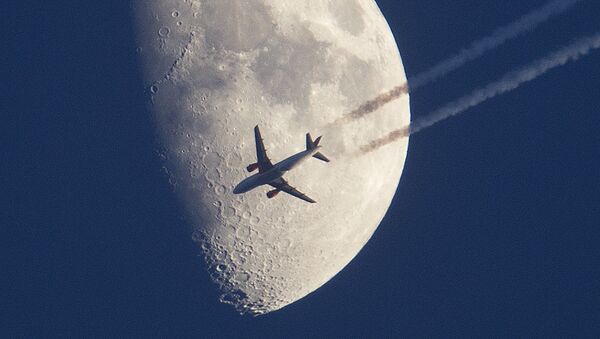 An aircraft passes the moon over Frankfurt, Germany - Sputnik International