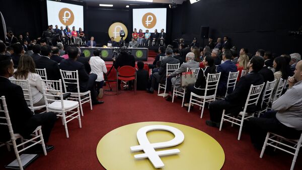 The Venezuelan cryptocurrency Petro logo is seen as Venezuela's President Nicolas Maduro speaks during a meeting with the ministers responsible for the economic sector at Miraflores Palace in Caracas, Venezuela March 22, 2018 - Sputnik International