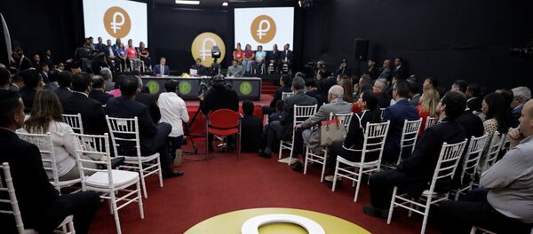 The Venezuelan cryptocurrency Petro logo is seen as Venezuela's President Nicolas Maduro speaks during a meeting with the ministers responsible for the economic sector at Miraflores Palace in Caracas, Venezuela March 22, 2018 The Venezuelan cryptocurrency Petro logo is seen as Venezuela's President Nicolas Maduro speaks during a meeting with the ministers responsible for the economic sector at Miraflores Palace in Caracas, Venezuela March 22, 2018 - Sputnik International