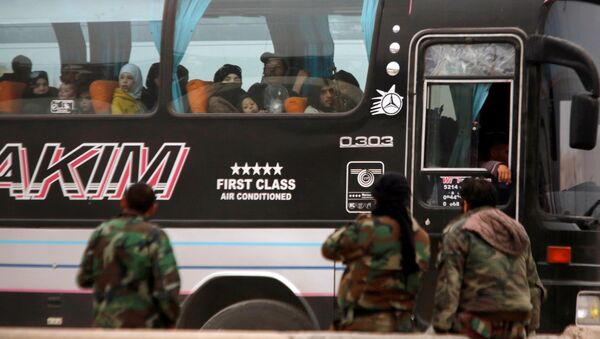 Syrian rebels and civilians look through a bus window as they leave Harasta in eastern Ghouta, in Damascus, Syria March 23, 2018 - Sputnik International