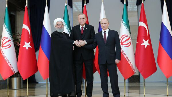 Russian President Vladimir Putin, Turkish President Recep Tayyip Erdogan and Iranian President Hassan Rouhani, right to left, pose for a photo before a meeting in Ankara - Sputnik International
