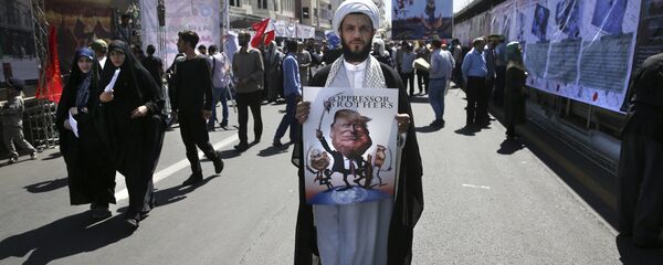 A clergyman holds a poster showing caricatures of U.S. President Donald Trump, center, Israeli Prime Minister Benjamin Netanyahu, left, and Saudi Arabia's King Salman in an annual pro-Palestinian rally marking Al-Quds (Jerusalem) Day in Tehran, Iran, Friday, June 23, 2017 A clergyman holds a poster showing caricatures of U.S. President Donald Trump, center, Israeli Prime Minister Benjamin Netanyahu, left, and Saudi Arabia's King Salman in an annual pro-Palestinian rally marking Al-Quds (Jerusalem) Day in Tehran, Iran, Friday, June 23, 2017 - Sputnik International