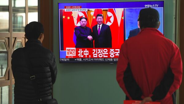 People watch a television news about a visit to China by North Korean leader Kim Jong Un, at a railway station in Seoul - Sputnik International