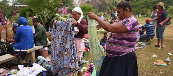 Central American migrants taking part in the Migrant Via Crucis caravan towards the United States pack their belongings as they prepare to leave a sport complex where they were camping in Matias Romero, Oaxaca State, Mexico Central American migrants taking part in the Migrant Via Crucis caravan towards the United States pack their belongings as they prepare to leave a sport complex where they were camping in Matias Romero, Oaxaca State, Mexico - Sputnik International