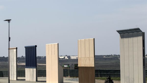 A US border patrol quad is seen next to US President Donald Trump's border wall prototypes from Tijuana, northwestern Mexico - Sputnik International
