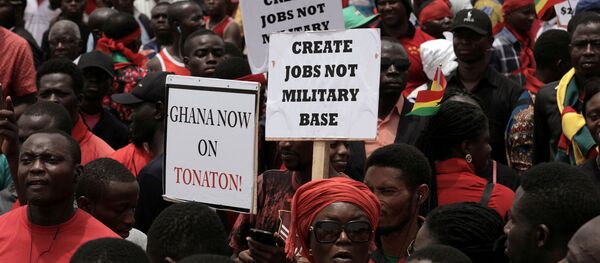 Demonstrators carry banners as they march during a protest in Ghana's capital Accra against the expansion of its defence cooperation with the United States, Ghana March 28, 2018. Demonstrators carry banners as they march during a protest in Ghana's capital Accra against the expansion of its defence cooperation with the United States, Ghana March 28, 2018. - Sputnik International