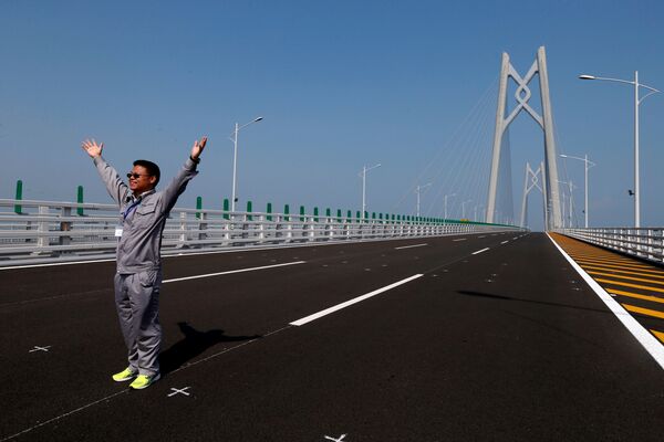A man poses on a section of the Hong Kong-Zhuhai-Macau Bridge, to be opened in Zhuhai, China March 28, 2018 - Sputnik International