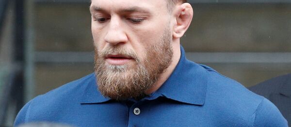 Ultimate fighting star Conor McGregor, center, is escorted by New York Court Police officers after a hearing at the Brooklyn Criminal Court, Friday, April 6, 2018, in New York Ultimate fighting star Conor McGregor, center, is escorted by New York Court Police officers after a hearing at the Brooklyn Criminal Court, Friday, April 6, 2018, in New York - Sputnik International