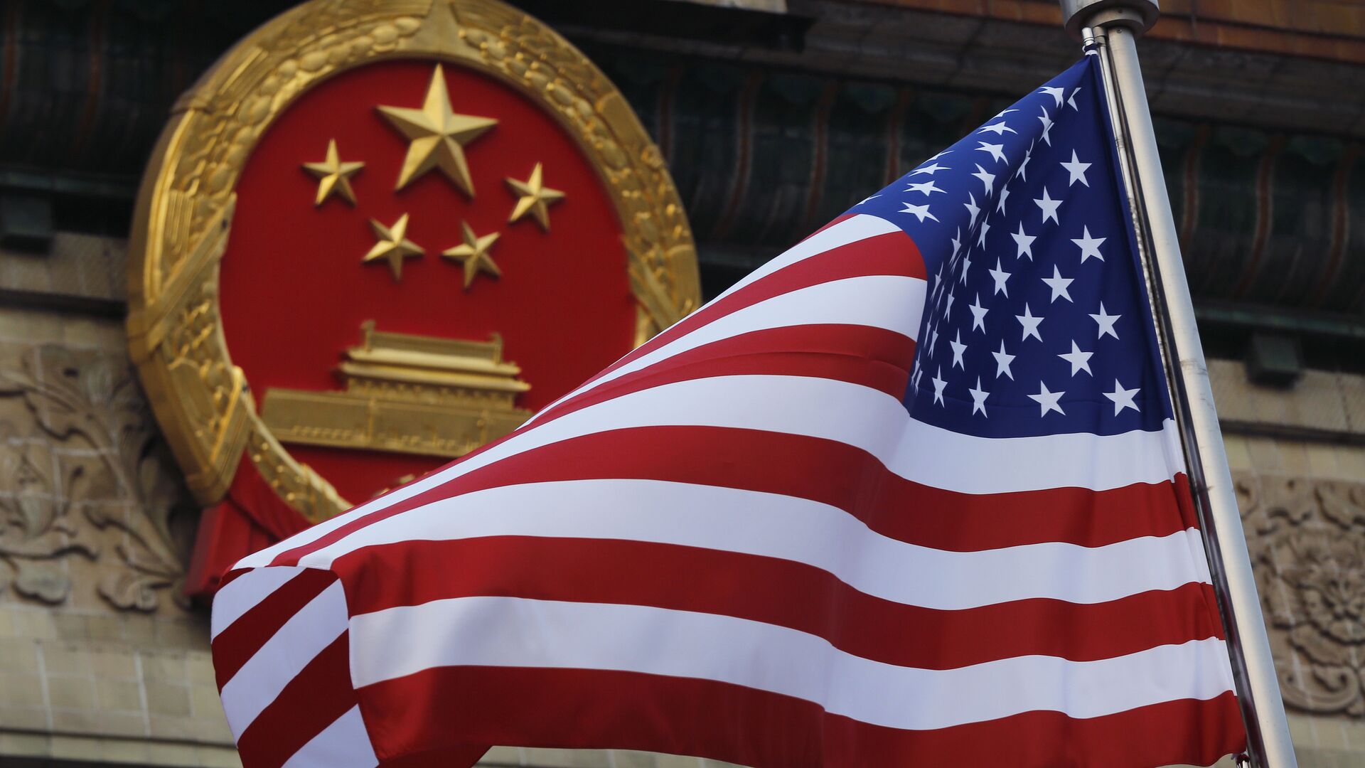 FILE - In this Nov. 9, 2017 file photo, an American flag is flown next to the Chinese national emblem during a welcome ceremony for visiting U.S. President Donald Trump outside the Great Hall of the People in Beijing - Sputnik International, 1920, 03.08.2022