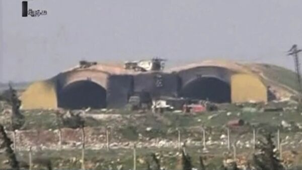 This frame grab from video provided by the Syrian official TV, a Syrian government channel that is consistent with independent AP reporting, shows the burned and damaged hangar warplanes which attacked by U.S. Tomahawk missiles, at the Shayrat Syrian government forces airbase, southeast of Homs, Syria, early Friday April, 7, 2017 - Sputnik International