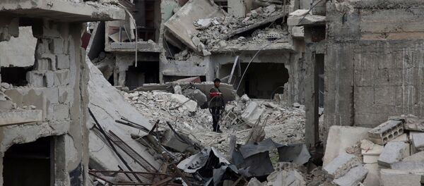 A man stands on rubble of damaged buildings in the besieged town of Douma, Eastern Ghouta, in Damascus, Syria March 30, 2018 A man stands on rubble of damaged buildings in the besieged town of Douma, Eastern Ghouta, in Damascus, Syria March 30, 2018 - Sputnik International