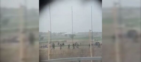 Palestinian protesters rush to aid a man struck by sniper fire from the Israeli Defense Forces at a November 22 protest. Palestinian protesters rush to aid a man struck by sniper fire from the Israeli Defense Forces at a November 22 protest. - Sputnik International