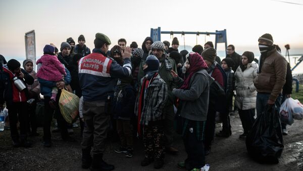 (File) Syrian and Afghan migrants and refugees wait after being caught by Turkish gendarme on January 27, 2016 at Canakkale's Kucukkuyu district - Sputnik International