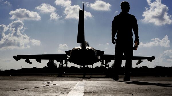 In this Thursday, Sept. 22, 2016 photo, a British soldier walks by a Typhoon aircraft before take off for a mission in Iraq, at RAF Akrotiri, near the southern coastal city of Limassol, in Cyprus - Sputnik International