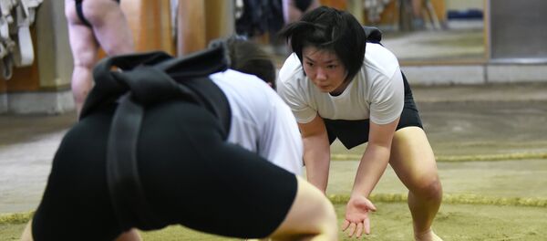 In a photograph taken on January 25, 2015, female sumo wrestler Sayaka Matsuo (R) fights with her teammate Shiori Kanehira (L) during a training session at Nihon University's sumo club in Tokyo In a photograph taken on January 25, 2015, female sumo wrestler Sayaka Matsuo (R) fights with her teammate Shiori Kanehira (L) during a training session at Nihon University's sumo club in Tokyo - Sputnik International