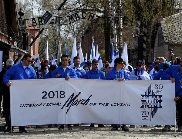 Participants open the March of the Living, a yearly Holocaust remembrance march between the former death camps of Auschwitz and Birkenau in Oswiecim Participants open the March of the Living, a yearly Holocaust remembrance march between the former death camps of Auschwitz and Birkenau in Oswiecim - Sputnik International